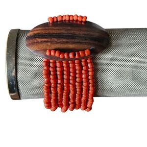 Multi Stranded Red Seed Bracelet With Wood Accent.